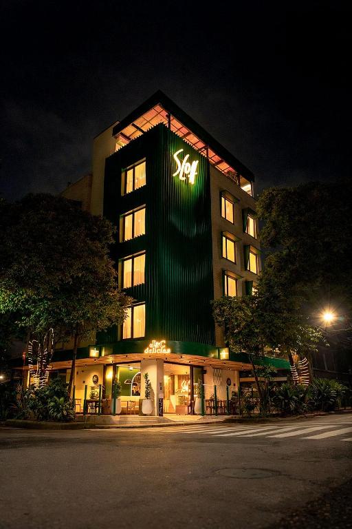 a building with a sign on the side of it at Sloh Hotel & Bar Manila Medellin in Medellín
