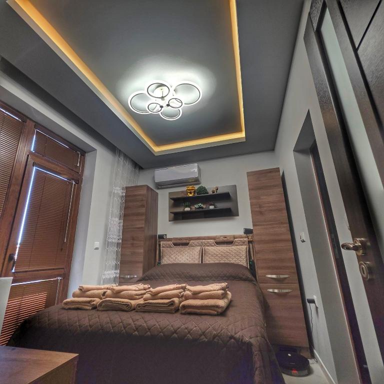 a large bed in a room with a ceiling at DN Kiten in Kiten