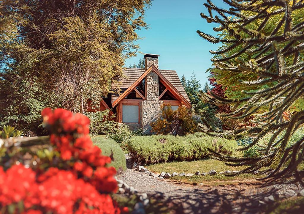 a small house in the middle of a garden at Tillka - Casas de Montaña in Villa La Angostura