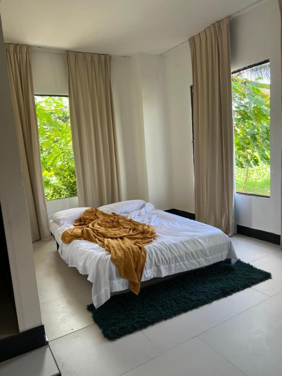 a bedroom with a bed with a blanket on it at Salo in Georgetown