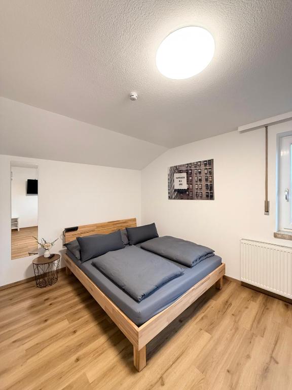 a bedroom with a large bed in a room at Sleep & Go Höchst in Höchst