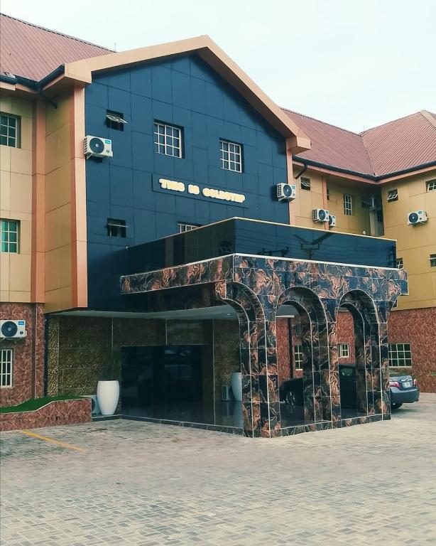 a large building with an archway in front of it at Goldstep Hotel Effurun in Warri