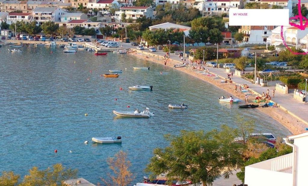 a beach with boats and people in the water at Apartment Zvonko in Metajna