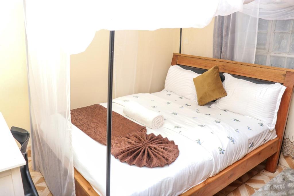 a bed in a room with a glass window at HOBRA HOMEs -Naivasha B in Naivasha