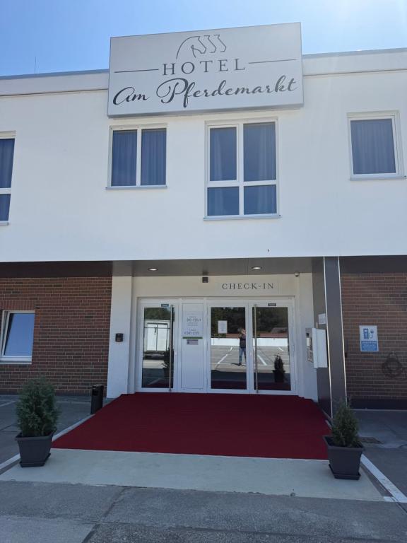 a building with a sign that reads hotel an ambulance at Hotel am Pferdemarkt in Aurich
