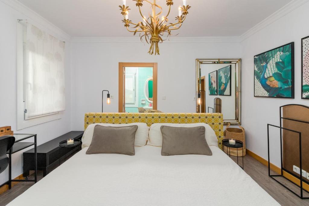 a bedroom with a large bed with a yellow headboard at La Fuente 33 in Castro-Urdiales