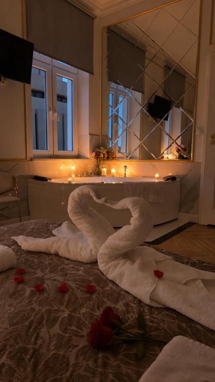 a bathroom with a bath tub with towels on the floor at Apartament z Jacuzzi Nova Bydgoszcz in Bydgoszcz