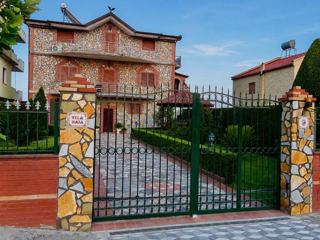 a black gate in front of a house at VilaHasa Private Villa in Tërbuf