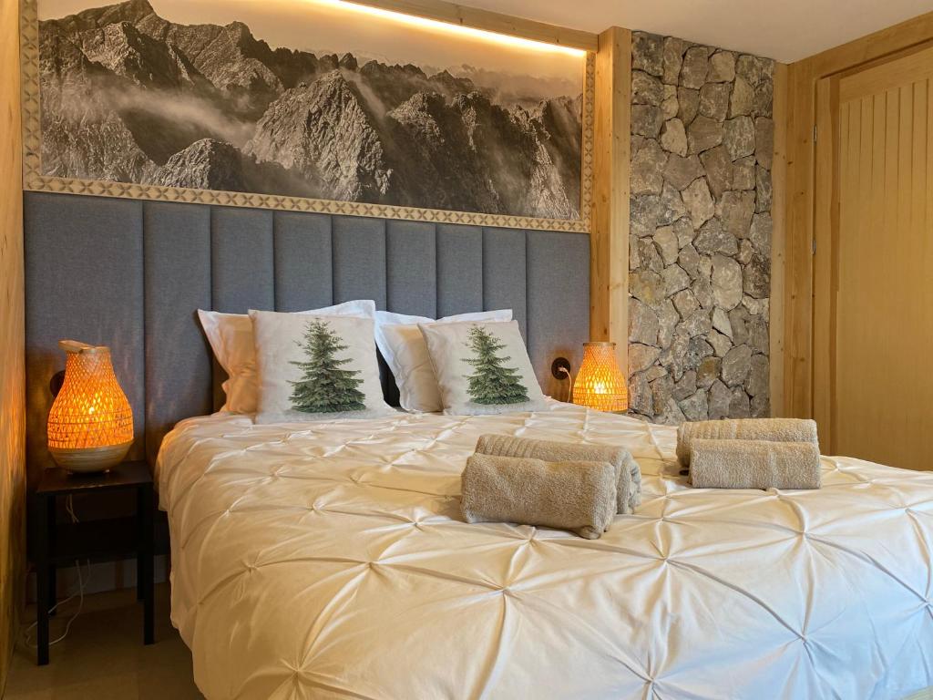 a large white bed with two christmas trees on it at Orla Przystań in Gliczarów Górny