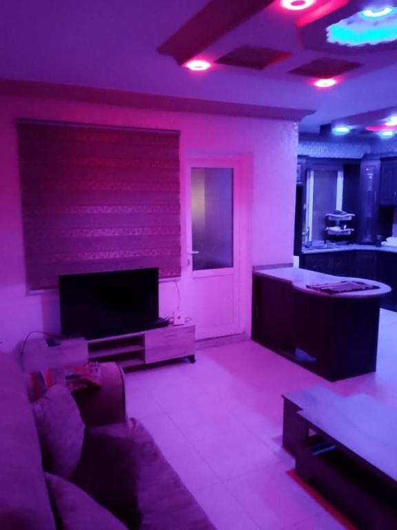 a living room with a couch and a tv at شقة 24 in Irbid