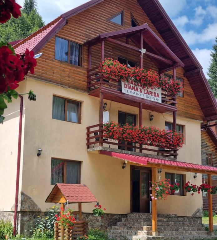 a building with flowers on the balconies of it at Cabana Diana&Larisa in Arieşeni