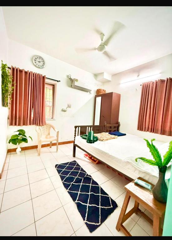 a bedroom with a large bed in a room at Serene Guest House ll 2 Ac Rooms ll WiFi ll Tv ll Big Garden in Lonavala