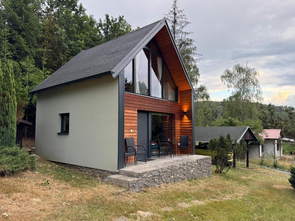 a small house with a white and wood at Chata Pod Dubem Kameňák in Moravany