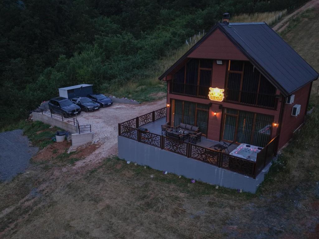 an overhead view of a house with two cars parked at Villa Loni in Pozharan