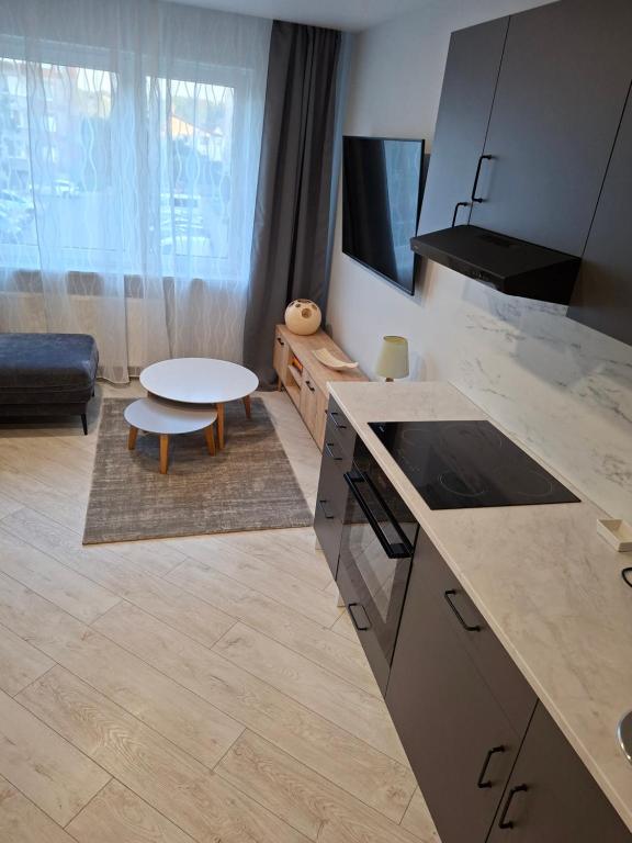 a kitchen with a counter top and a table at Atokvėpis sielai in Šilutė