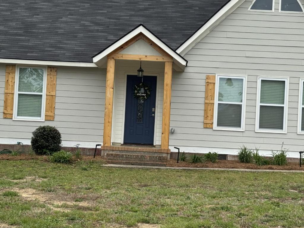 a house with a blue door with a wreath on it at Charming Room in Martinez in Martinez