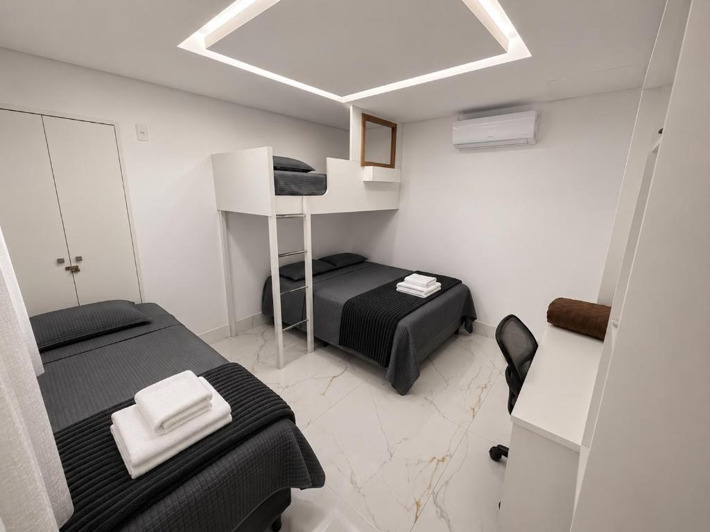 a small room with two beds in a room at Aconchego de Lugar - Eri & Douglas - 4 in Belo Horizonte