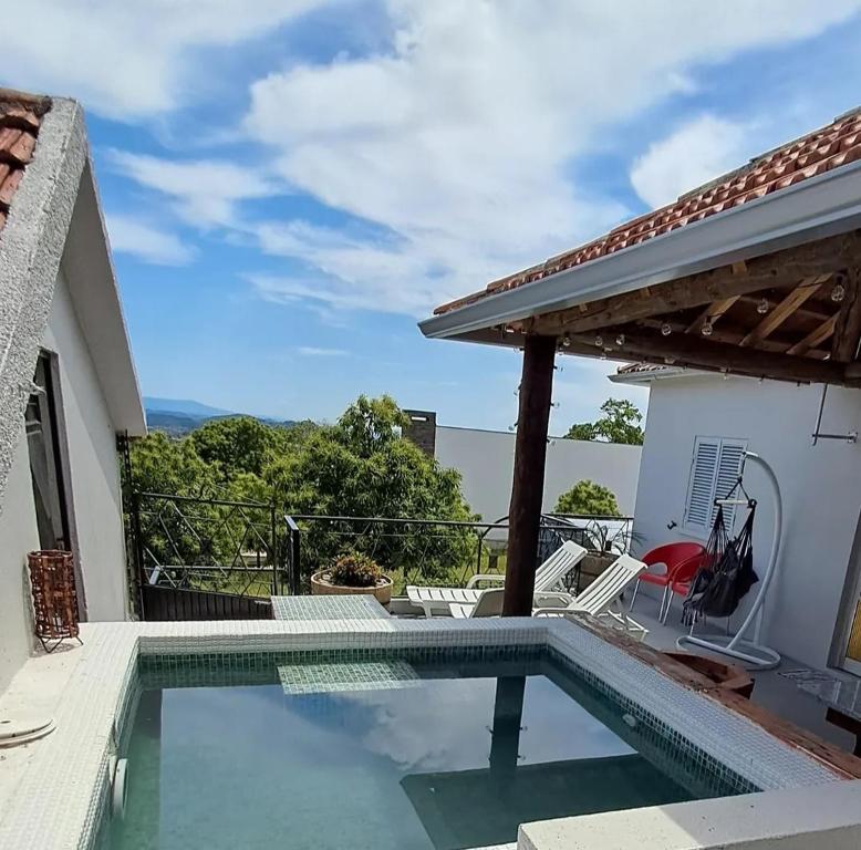 a swimming pool with a view of a house at Casa do Tempo Espinhoso in Vinhais