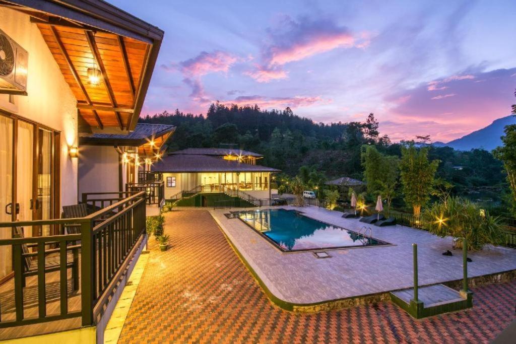 an image of a house with a swimming pool at Okwin Resort Nawalapitiya in Kandy