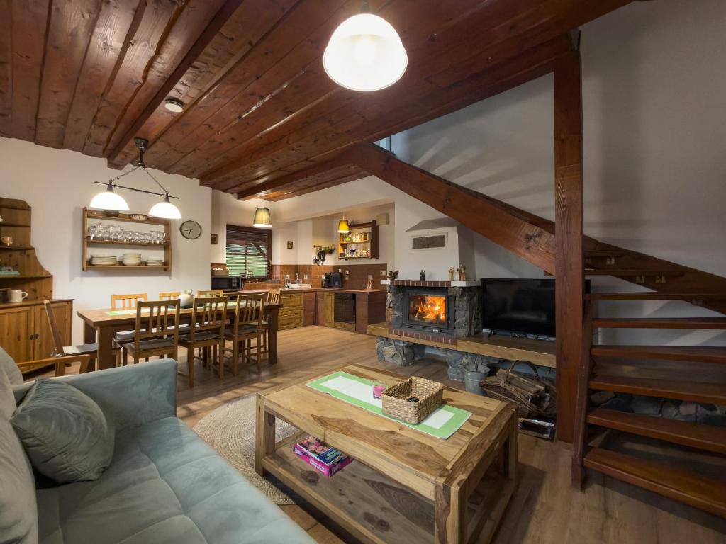 a living room with a couch and a fireplace at Chata na Lániku in Švošov