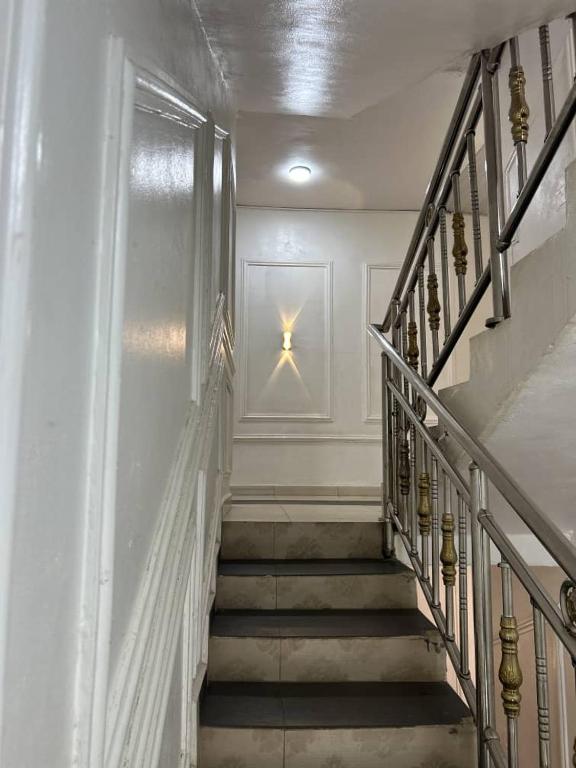 a staircase in a building with a star on the wall at Smarthome Hotel in Benin City