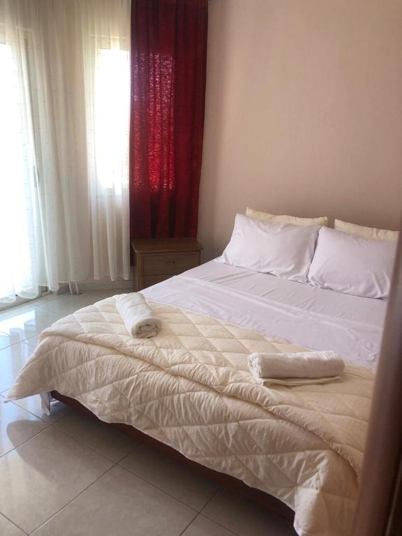 a bed with two towels on it in a bedroom at Pogradec Lakefront Apartment in Pogradec
