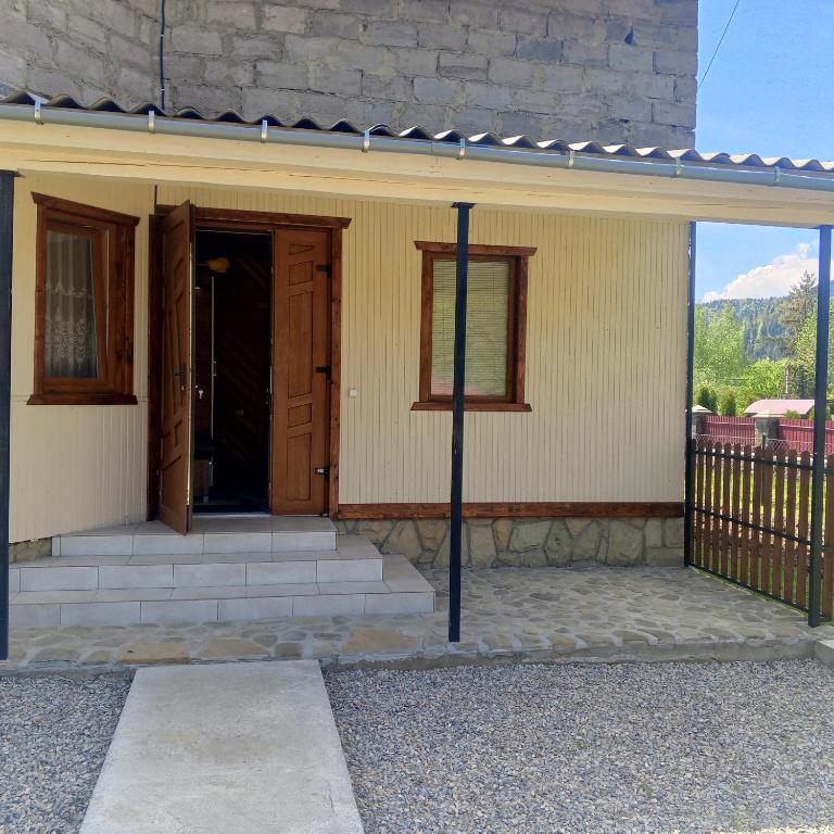 a front door of a house with a porch at Оксана та Назар in Mykulychyn