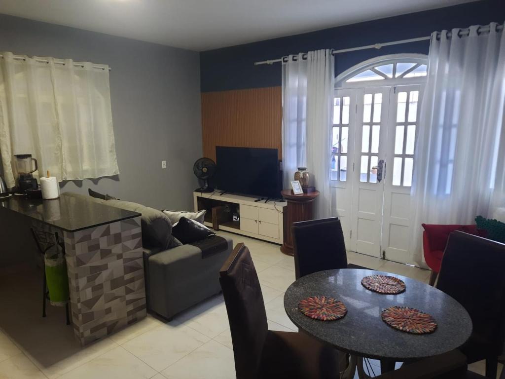 a living room with a couch and a table at Machado Monteiro in Guarapari