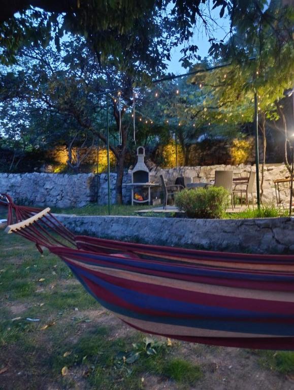 a wooden boat sitting on the grass in a yard at Pergola Garden in Nikšić