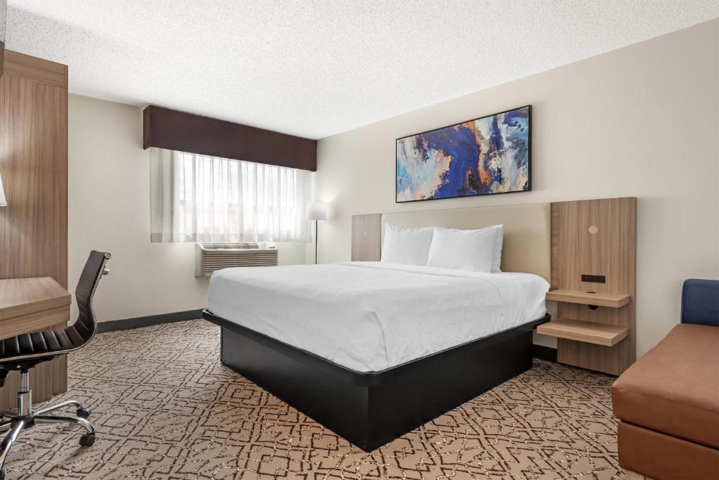 a hotel room with a bed and a desk at Best Western Airport Inn in Calgary