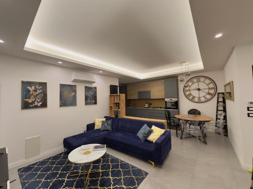 a living room with a blue couch and a table at Dorian Gray Luxury Suite in Trieste