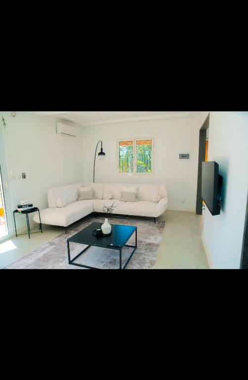 a living room with a couch and a table at Villa Domi in Antsiranana