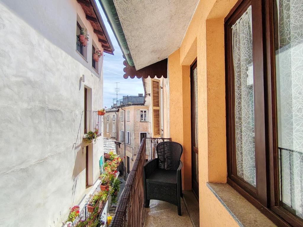 a balcony of a building with a chair on it at Will House in Lanzo Torinese