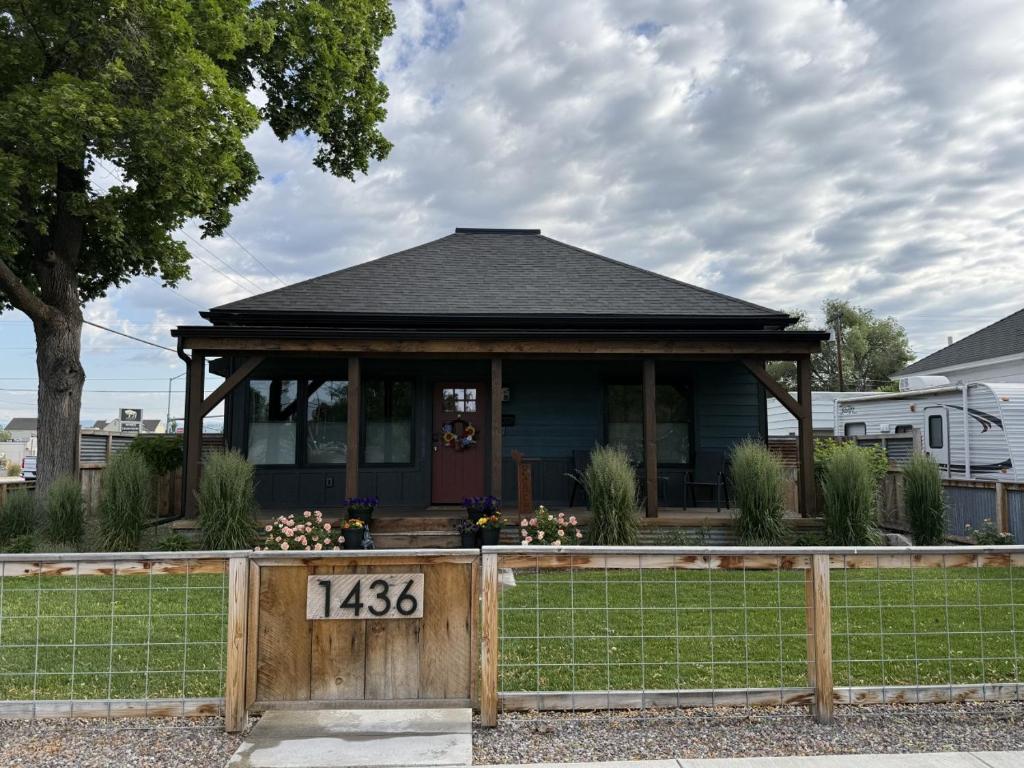 a house with a porch with a wooden fence at ZOOTown The Blue Bungalow in Missoula