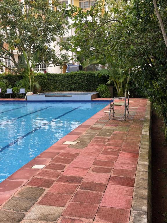 a bench sitting next to a swimming pool at Bubuli country club in Lyamutundwe