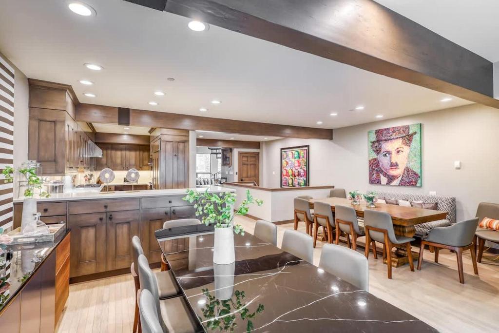 a kitchen and dining room with a table and chairs at Vail Ski-In Ski-Out Chalet in Vail