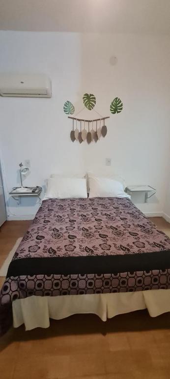 a bedroom with a bed with a brown blanket at Mimi House in Posadas