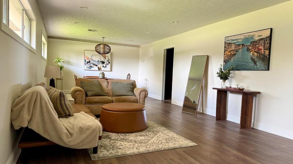 a living room with a couch and a chair at Sabana in Lake Charles