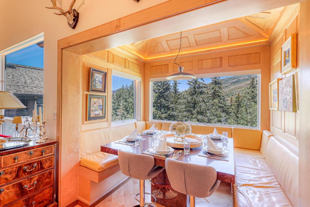 a dining room with a table and chairs and a window at Ski-in Ski-Out the View in Vail in Vail
