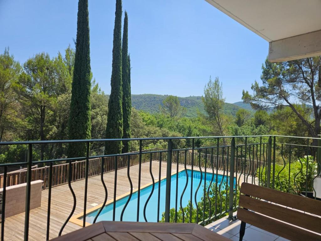 a balcony of a house with a swimming pool at Appartement Belle Vue in Gréoux-les-Bains