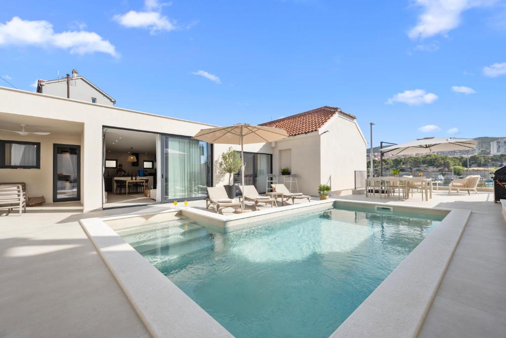 a swimming pool in the backyard of a house at Villa Olea Mandalina in Šibenik