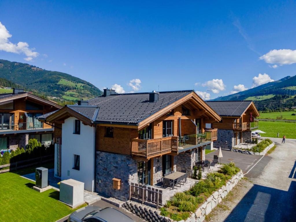 an aerial view of a house with mountains in the background at Tauernlodge Chalet Salzach in Niedernsill