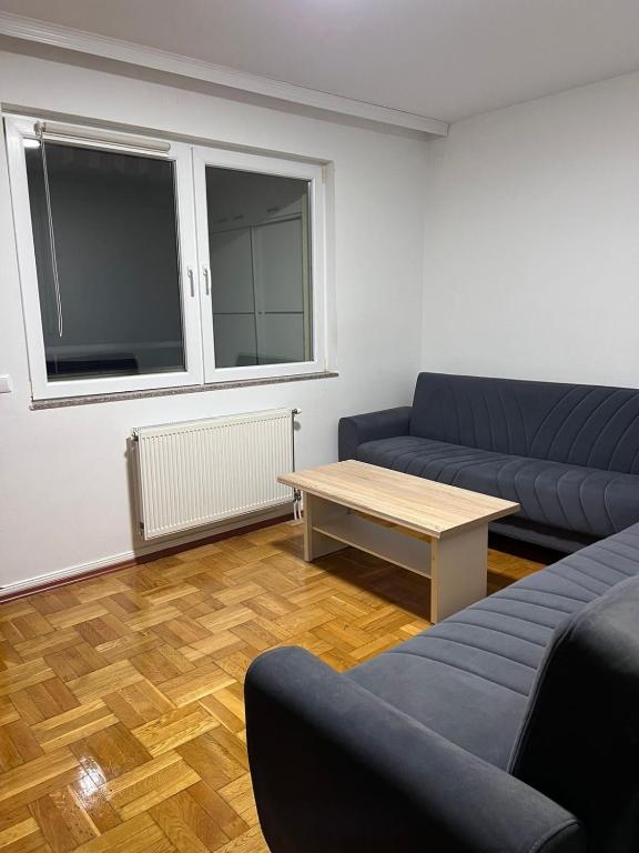 a living room with two couches and a coffee table at Dardi in Peje
