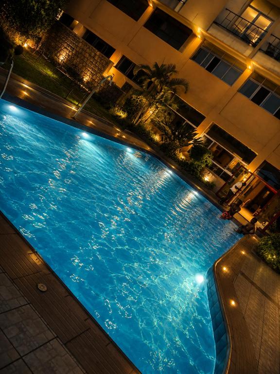 a large swimming pool in a building at night at KIGALI E6 APARTMENTs RESORTS in Kigali