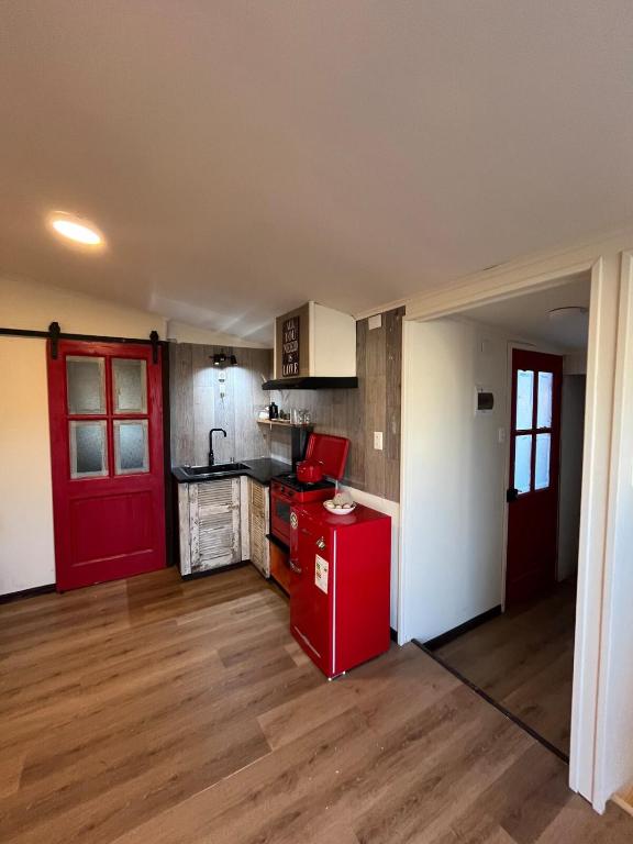 a kitchen with a red refrigerator in a room at Casita Loica in Chaitén