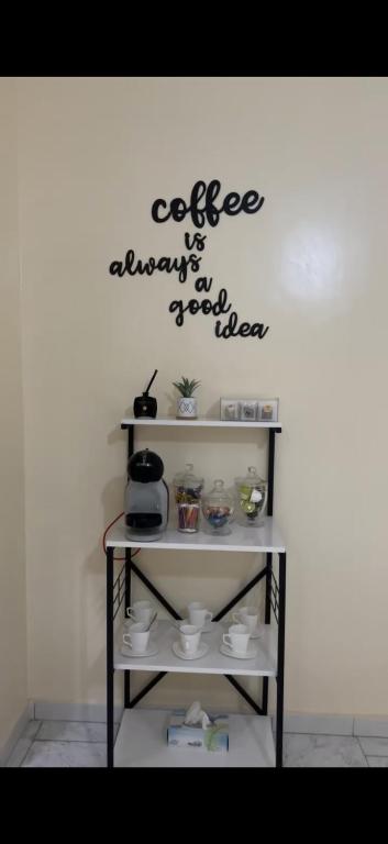 a shelf with a coffee sign on a wall at Relax appartement in Nouakchott
