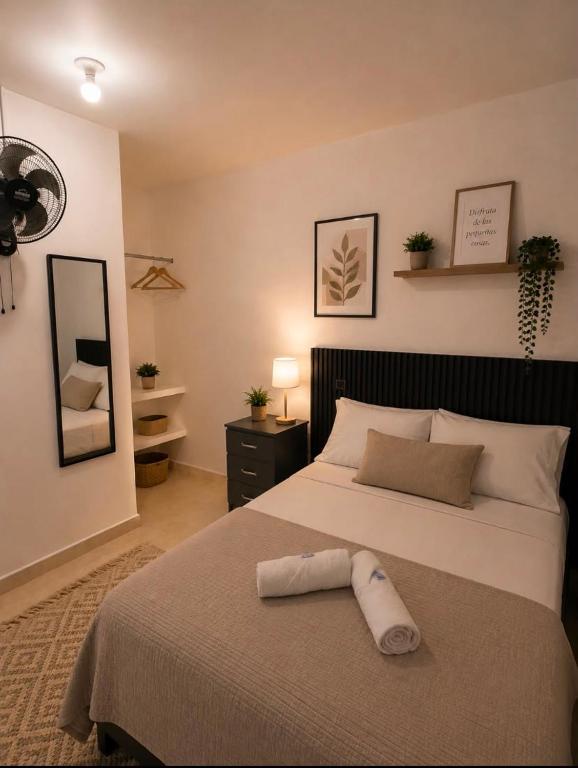 a bedroom with a large bed with a pillow on it at Ortega La 33 Hotel y Spa in Medellín