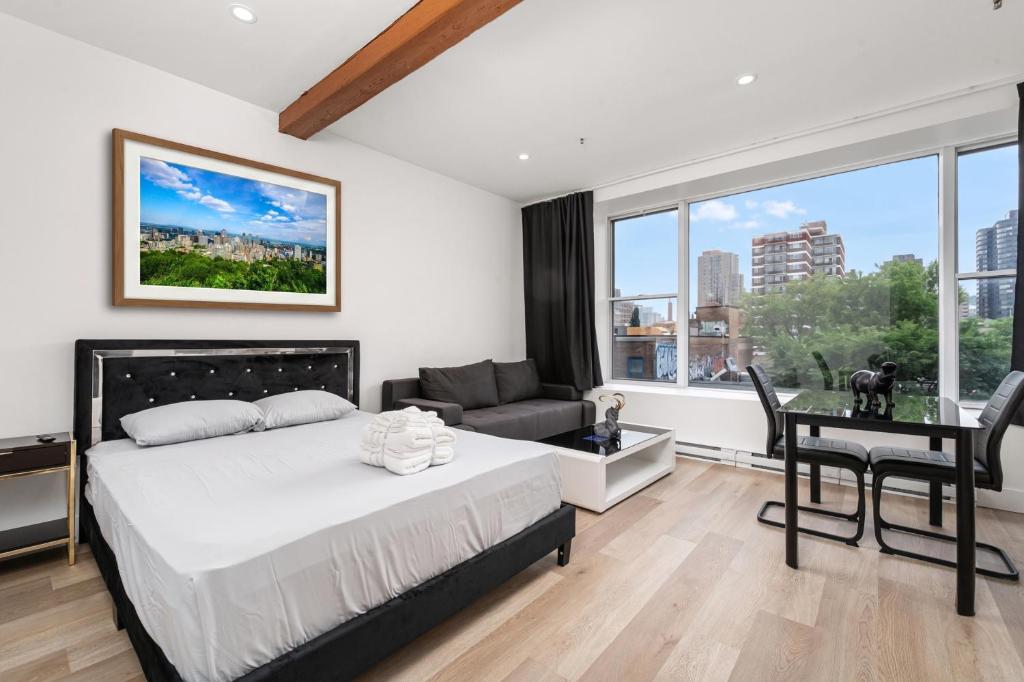 a bedroom with a bed and a desk and a window at Bonjour Plateau Hotel in Montreal