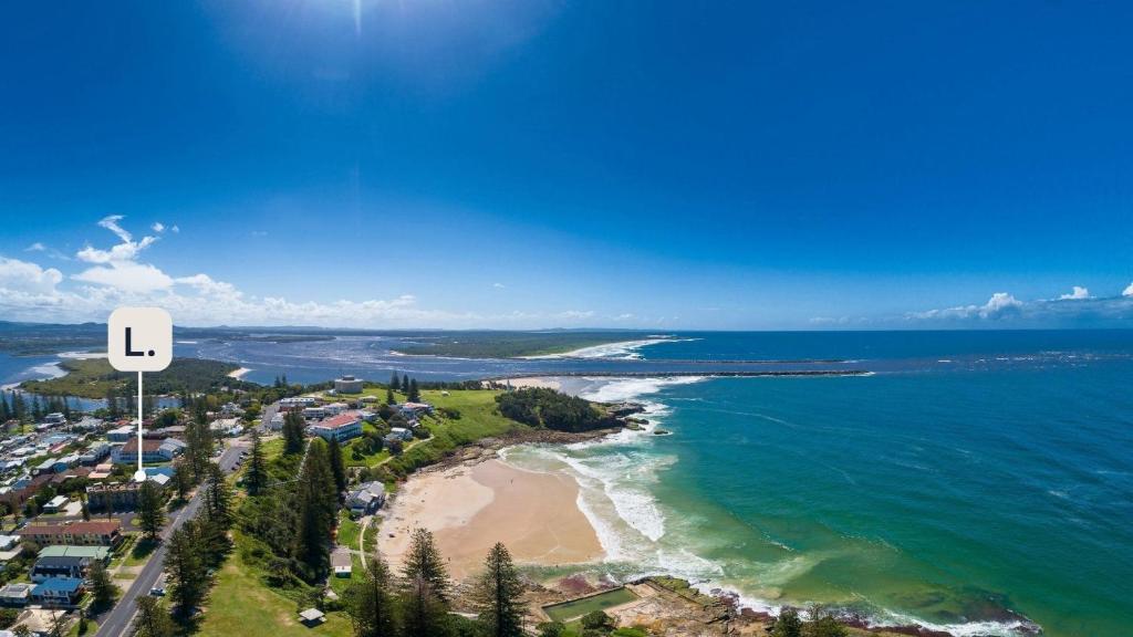 an aerial view of a beach and the ocean at Seaspray Views - Lifestyle Yamba in Yamba
