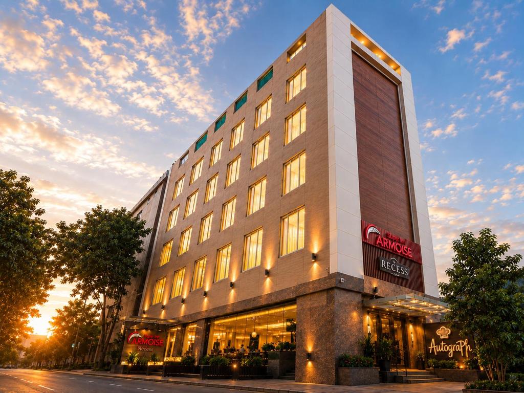 a tall building with a store on a street at Super Inn Armoise Hotel - Navrangpura, Ahmedabad in Ahmedabad